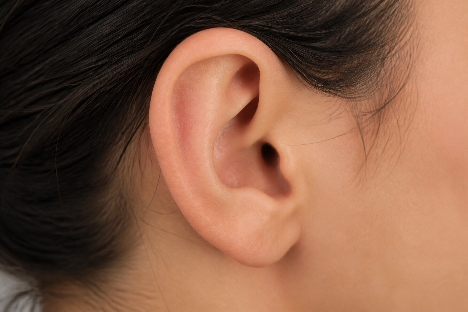 Close-up of a healed ear after otoplasty, showing minimal Otoplasty Scarring Facts behind the ear